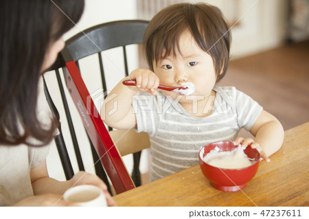 Child eating baby food Child eating baby food 47237611