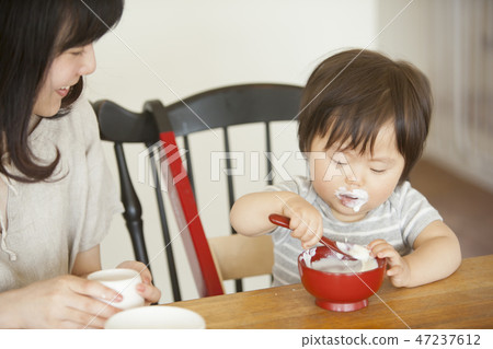 Child eating baby food Child eating baby food 47237612
