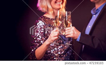Image of happy couple with champagne glasses with champagne on black background 47239183
