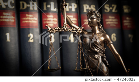 Statue of justice on books background 47240022