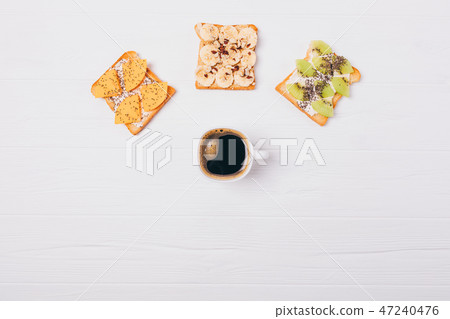Cup of coffee and three different fruit  47240476