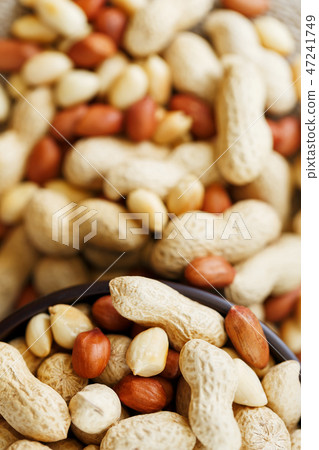 Peanuts in the shell and peeled close-up in cups. Peanuts in the shell and peeled close-up in cups. 47241749