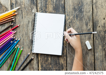 Girl hand drawing, blank paper and colorful pencil Girl hand drawing, blank paper and colorful pencil 47242575