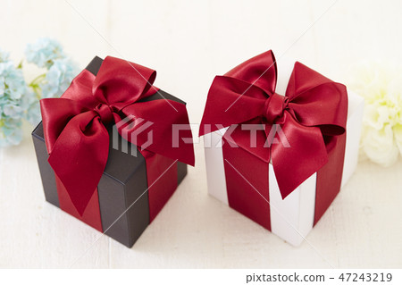 Red ribbon present box flower white background 47243219