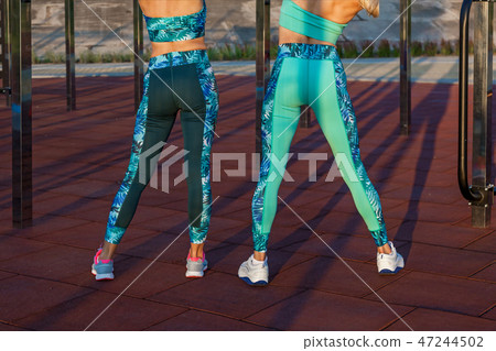girls doing exercises on the sports field girls doing exercises on the sports field 47244502