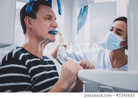 Concentrated brunette man doing x-ray picture of teeth 47245683