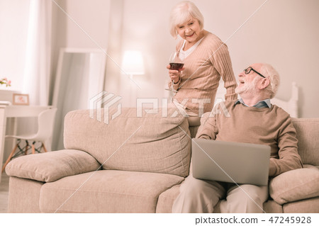 Relaxed mature female person enjoying red wine 47245928