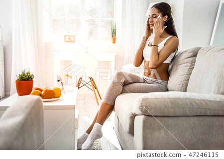 Attractive young female doing massage on her face 47246115