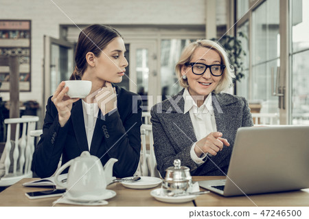 Mature businesswoman talking about new project to her daughter Mature businesswoman talking about new project to her daughter 47246500