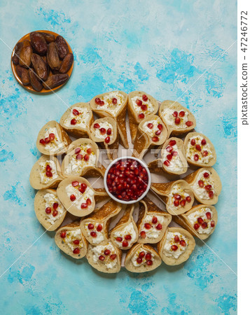 Traditional Arabic crepes stuffed with cream. 47246772