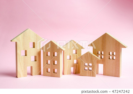 A lot of wooden houses on a pink background. A lot of wooden houses on a pink background. 47247242