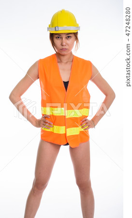 Studio shot of young Asian woman wearing construction worker costume Studio shot of young Asian woman wearing construction worker costume 47248280
