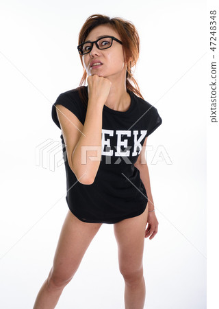 Studio shot of young Asian geek girl punching herself in the chi 47248348