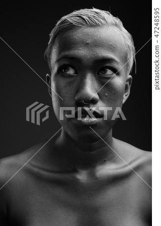 Young beautiful rebellious woman with short hair thinking 47248595