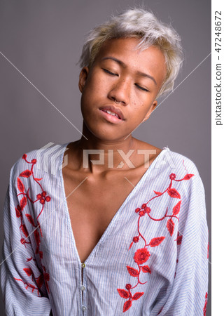 Young beautiful woman with short hair relaxing with eyes closed 47248672