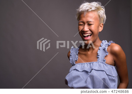 Young beautiful rebellious woman with short hair laughing Young beautiful rebellious woman with short hair laughing 47248686