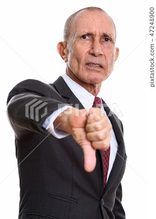 Studio shot of senior businessman giving thumb down  47248900