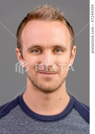 Face of handsome Caucasian man studio portrait against gray background 47249304
