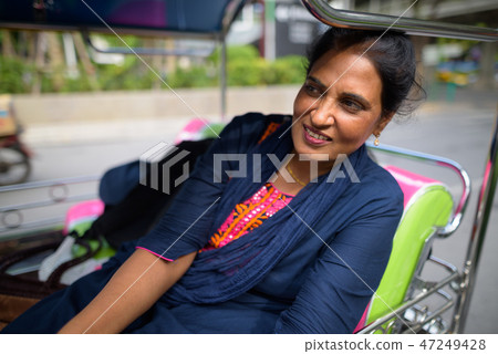 Mature beautiful Indian woman sitting in tuk tuk Mature beautiful Indian woman sitting in tuk tuk 47249428
