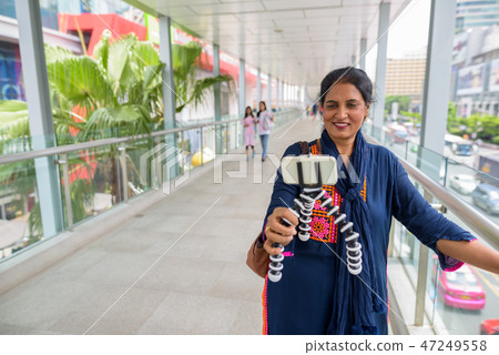 Mature beautiful Indian woman vlogging using mobile phone Mature beautiful Indian woman vlogging using mobile phone 47249558