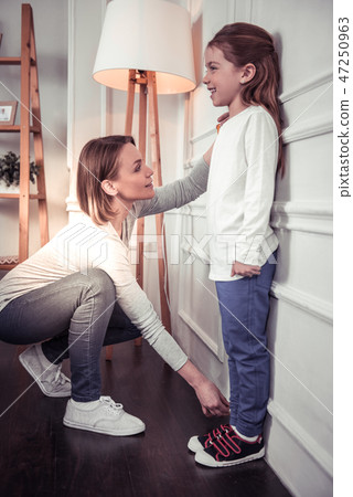 Nice cute girl standing near the wall 47250963