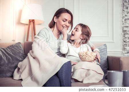 Nice happy cute girl feeding her mother Nice happy cute girl feeding her mother 47251033