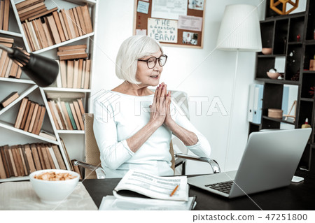Amazing retired female sitting in front of computer 47251800