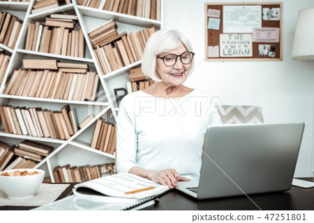 Cheerful senior woman working with great pleasure 47251801