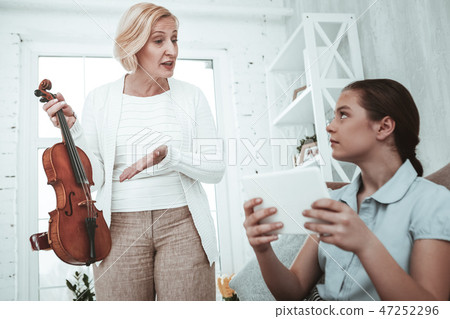 Unhappy senior woman having a quarrel with her granddaughter 47252296
