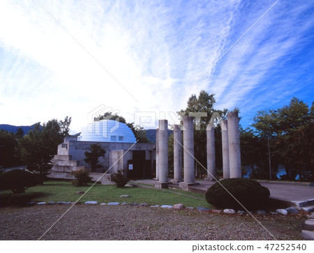 Taking a picture of the landscape of the Kotan Ainu Folk Museum near Lake Kusshiro, Hokkaido 47252540