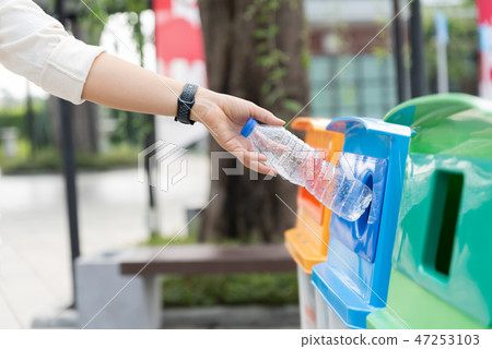 Closeup portrait woman hand throwing empty bottle Closeup portrait woman hand throwing empty bottle 47253103