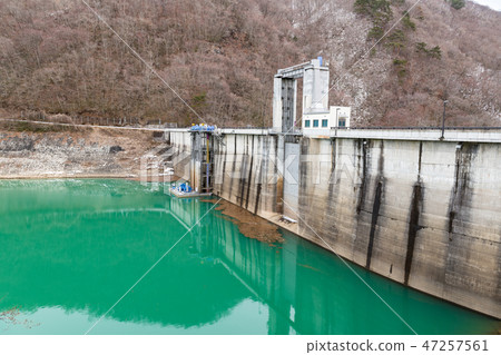 Kurikoma Dam in winter and Lake Kurikoma in emerald green Kurikoma Dam in winter and Lake Kurikoma in emerald green 47257561