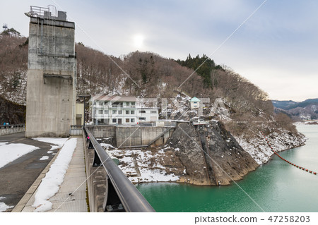 Kurikoma Dam in winter and Lake Kurikoma in emerald green 47258203