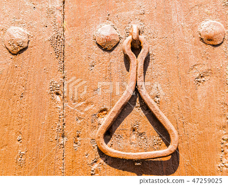 Door with brass knocker in the shape of a decor 47259025