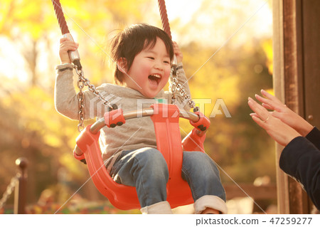 A boy playing with a swing A boy playing with a swing 47259277