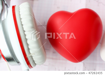 Red toy heart an heaphones on paper cardiogram Red toy heart an heaphones on paper cardiogram 47261435