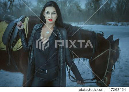 Woman witch with a horse. 47262464