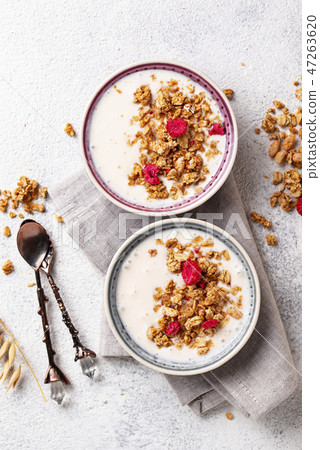 Granola with yogurt and dried raspberries Granola with yogurt and dried raspberries 47263620