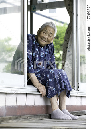 Grandma sitting on the curb 47264271