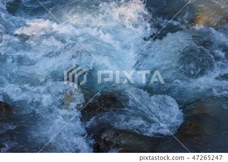 Blue flowing water stream of mountain river 47265247