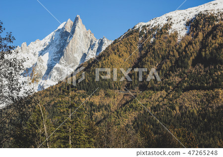 View of one snowy Alps mountain and green hill 47265248