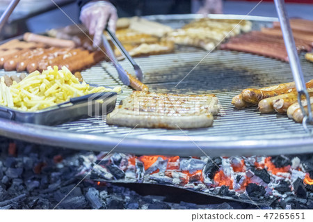 sausages and potatoes on the coals 47265651