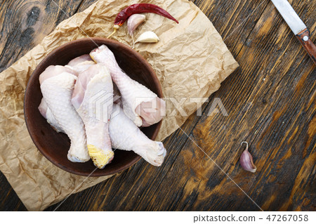 chicken legs on wooden background 47267058