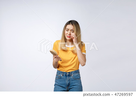 Unhappy Asian girl on the phone , Angry Asian woman talking phone with her boyfriend, isolated on Unhappy Asian girl on the phone , Angry Asian woman talking phone with her boyfriend, isolated on 47269597