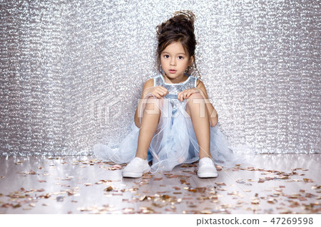 little child girl in dress sitting on the floor with confetti little child girl in dress sitting on the floor with confetti 47269598