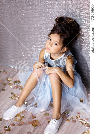 little child girl in dress sitting on the floor with confetti little child girl in dress sitting on the floor with confetti 47269600