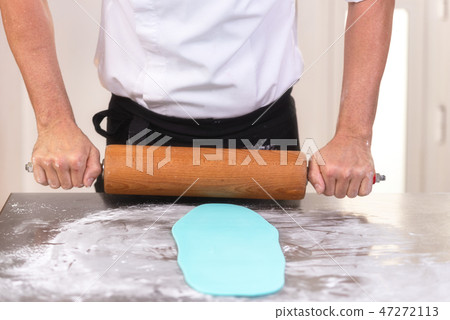 Professional confectioner making chocolate sweets at confectionery shop. 47272113