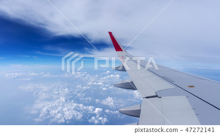 Plane wing on the blue sky and clouds Plane wing on the blue sky and clouds 47272141