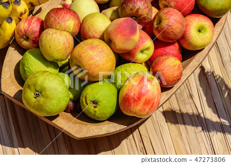 Various red and green fruits under the sunlight Various red and green fruits under the sunlight 47273806