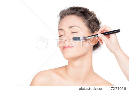 Black charcoal mask application on beautiful woman. Black charcoal mask application on beautiful woman. 47275036
